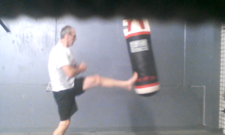 Punching and kicking a heavy bag for fitness